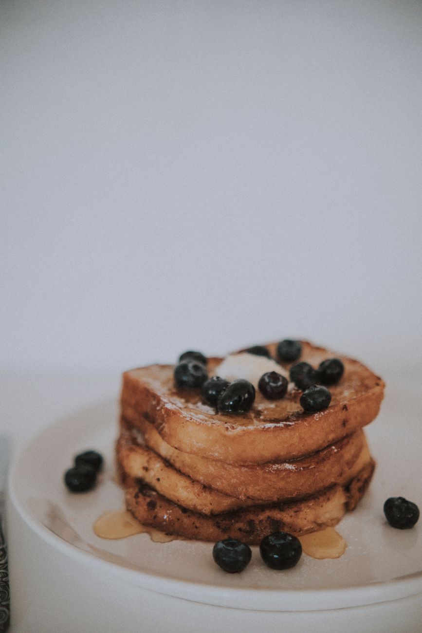A close-up of toasts topped with fresh blueberries