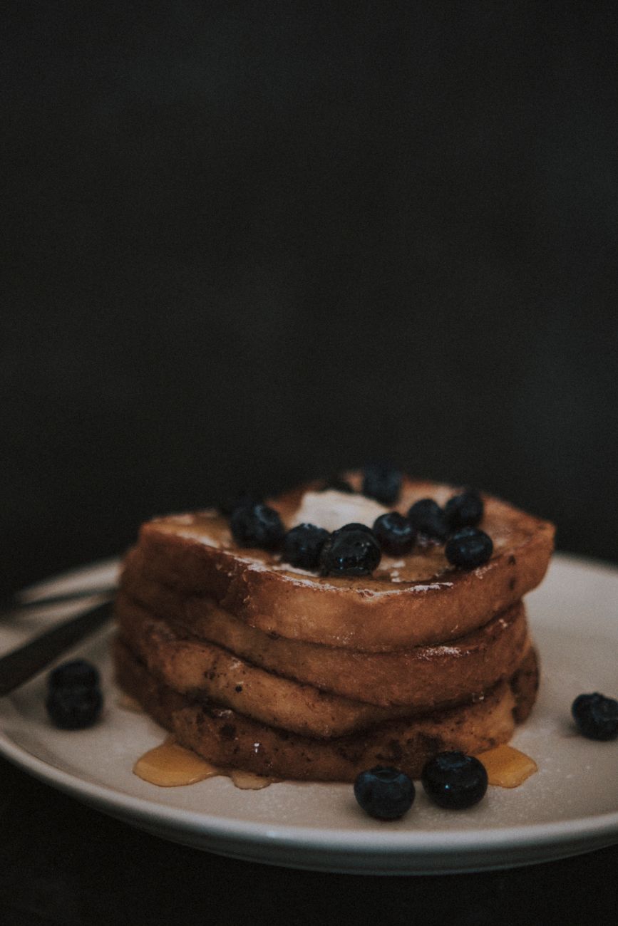 A plate of toasts topped with fresh fruit
