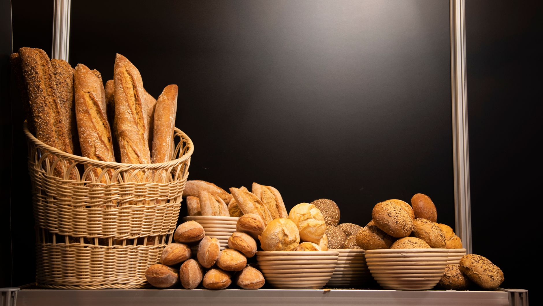 A variety of delicious breads displayed in a basket and bowls