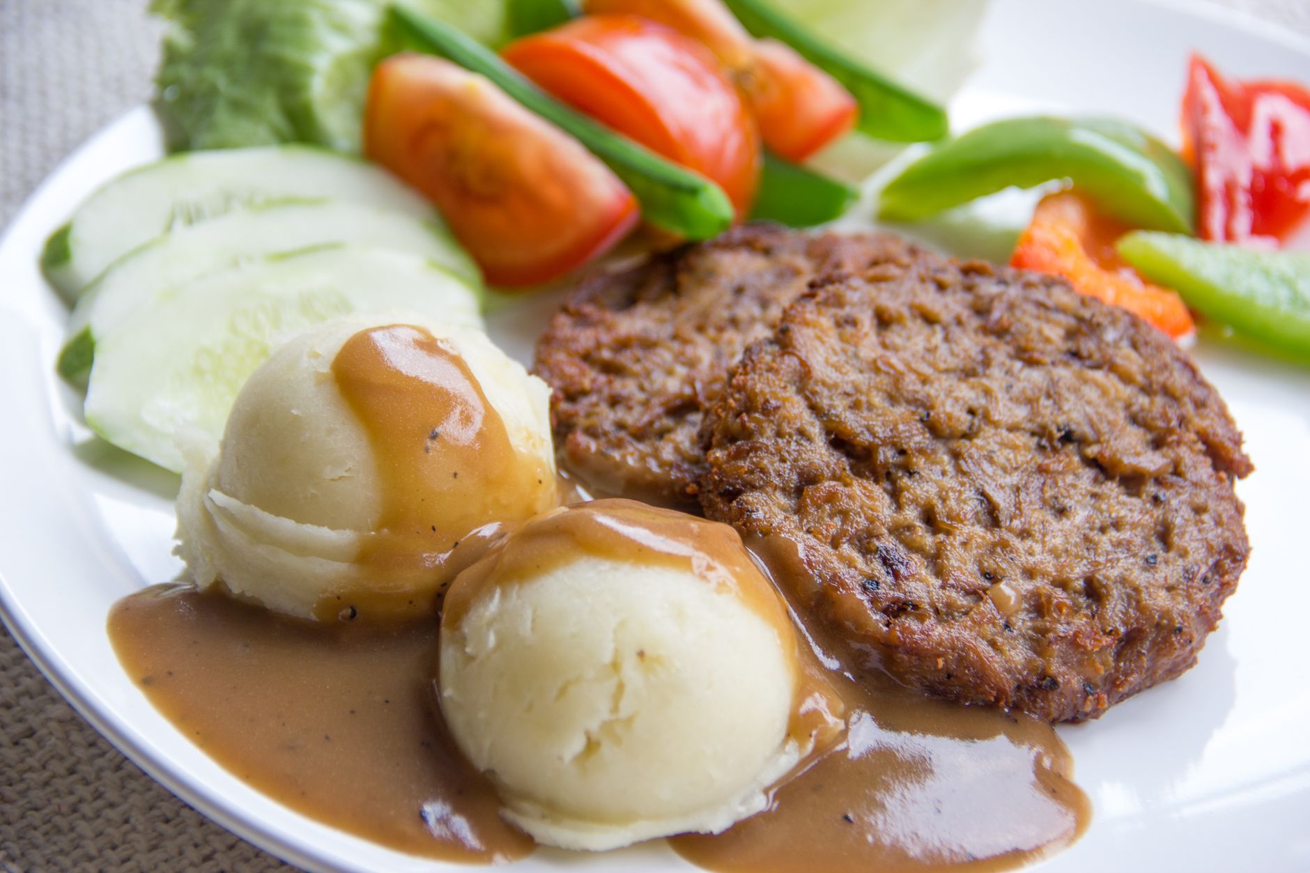 Delicious veggie patties served with mashed potatoes and fresh salad