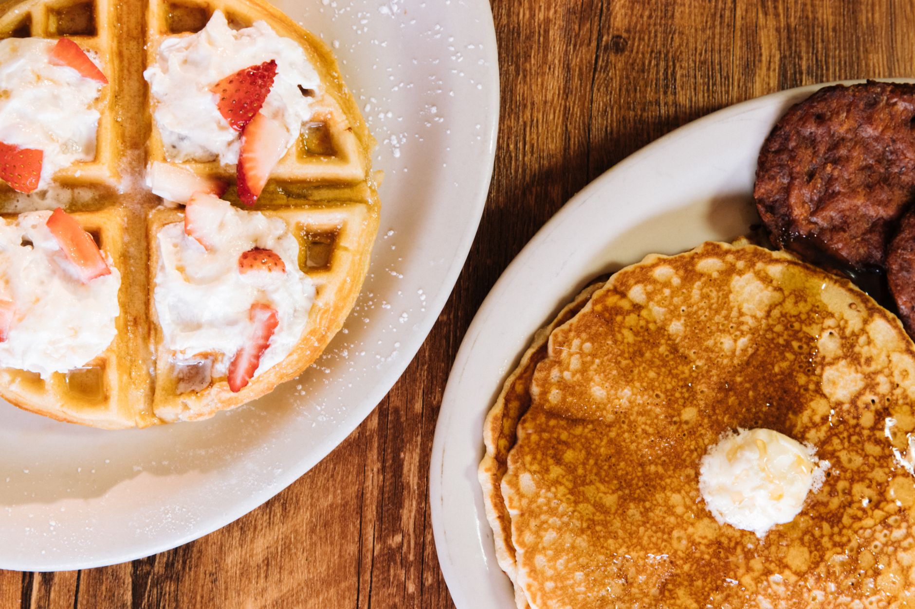 Waffles and pancakes served together on white ceramic plates