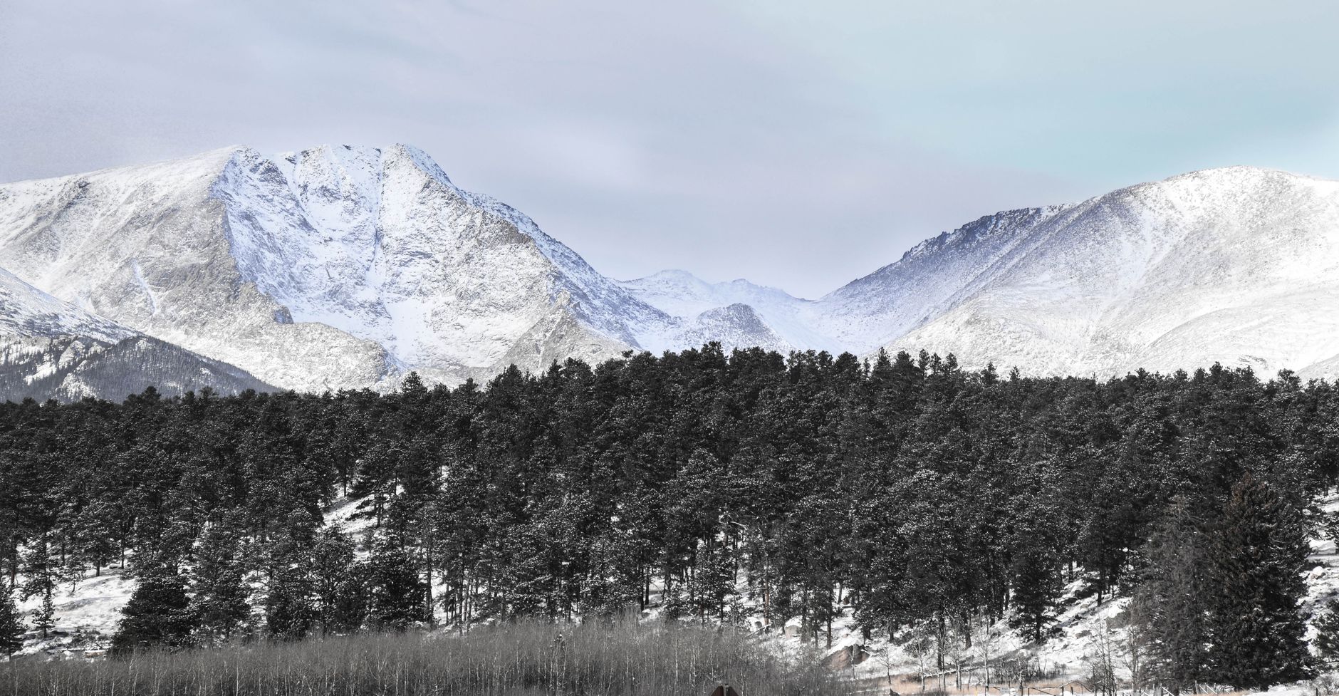 Snow-capped Rocky Mountains peaks under a winter sky